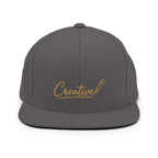 Embroidered snapback cap in gold script — Merlin Fashion